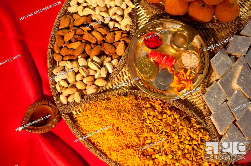 Assorted Diwali sweets and snacks with Diwali diya, Stock Photo, Picture  And Royalty Free Image. Pic. PNT-PIRF-20121004-SA0125 | agefotostock