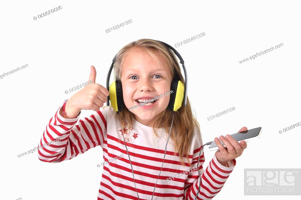 sweet little girl 7 years old with blonde hair and blue eyes listening to  music with headphones and..., Stock Photo, Picture And Low Budget Royalty  Free Image. Pic. ESY-033491330 | agefotostock