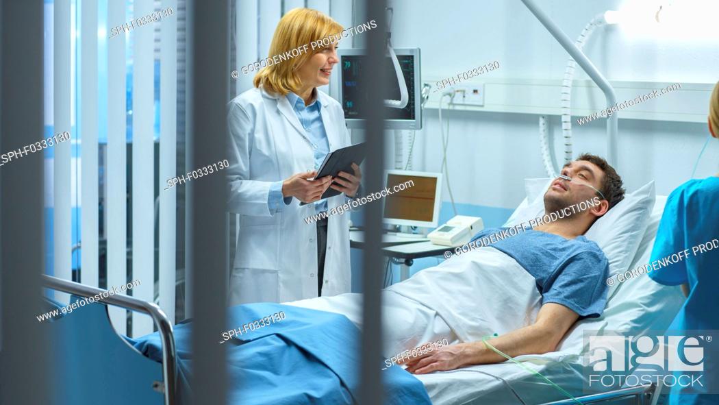 Stock Photo: Doctor visiting a recovering man lying in bed.