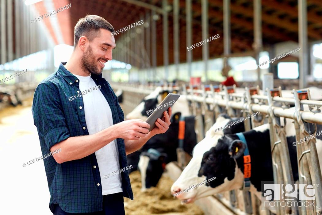 agriculture industry, farming, people, technology and animal husbandry  concept - young man or farmer..., Stock Photo, Picture And Low Budget  Royalty Free Image. Pic. ESY-030747420 | agefotostock