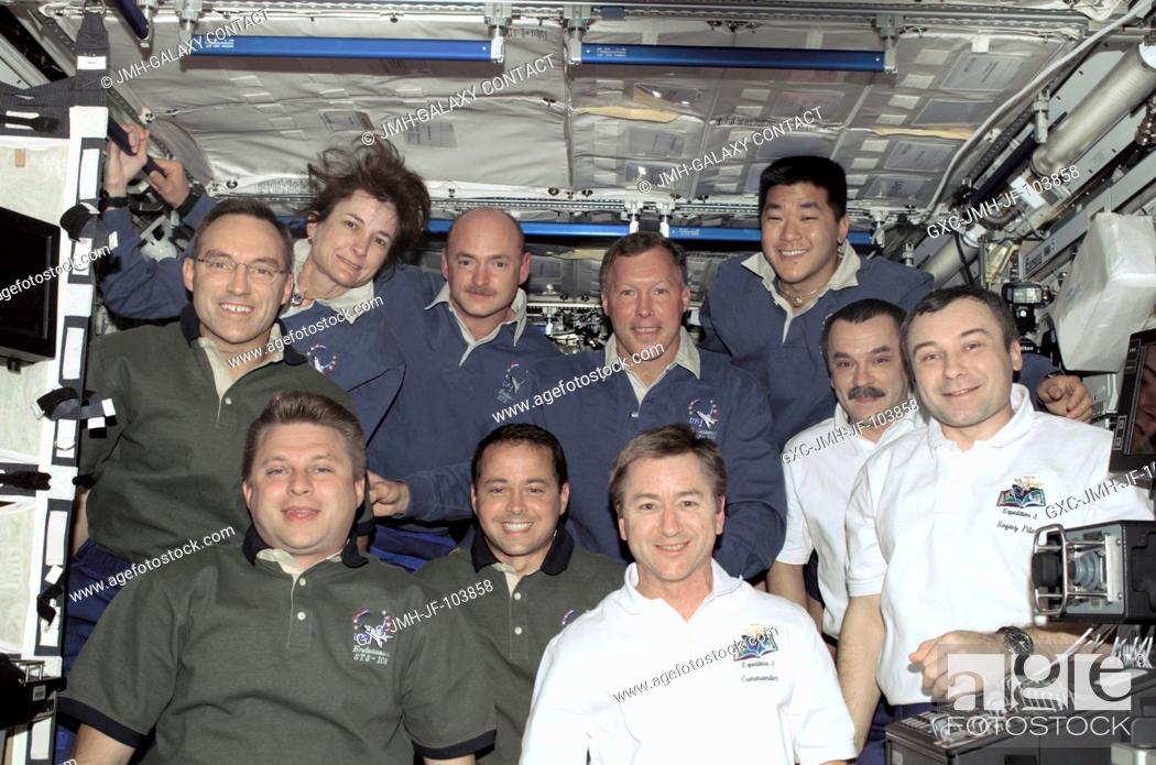 Stock Photo: The Expedition Four (green shirts), STS-108 (blue shirts), and Expediton Three (white shirts) crews assemble for a group photo in the Destiny laboratory on the.