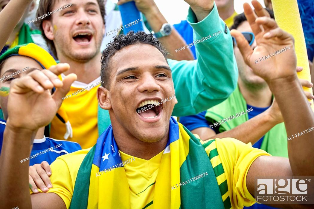 Stock Photo: Brazilian football fans cheering at match.