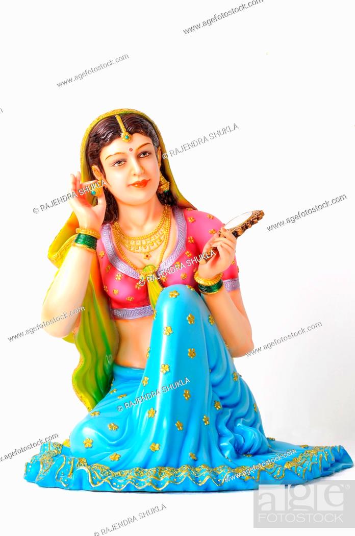 Clay figurine , statue of rajasthani young girl wearing earring with mirror  in her left hand, Stock Photo, Picture And Rights Managed Image. Pic.  DPA-RAJ-166590 | agefotostock