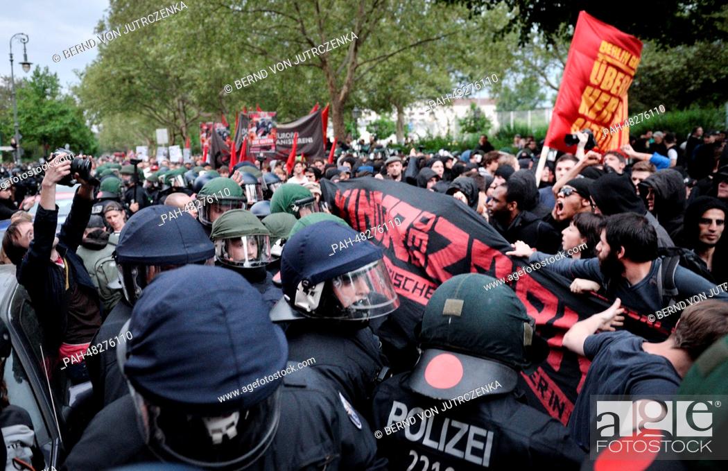 Stock Photo: People take part in the May Day demonstration go up against police officers in Berlin-Kreuzberg, Germany, 01 May 2014. The protest by left and leftist radical.