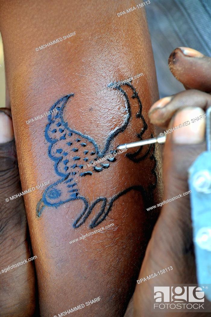 Man making eagle tattoo on his hand ; Pushkar fair ; Rajasthan ; India,  Stock Photo, Picture And Rights Managed Image. Pic. DPA-MSA-158113 |  agefotostock