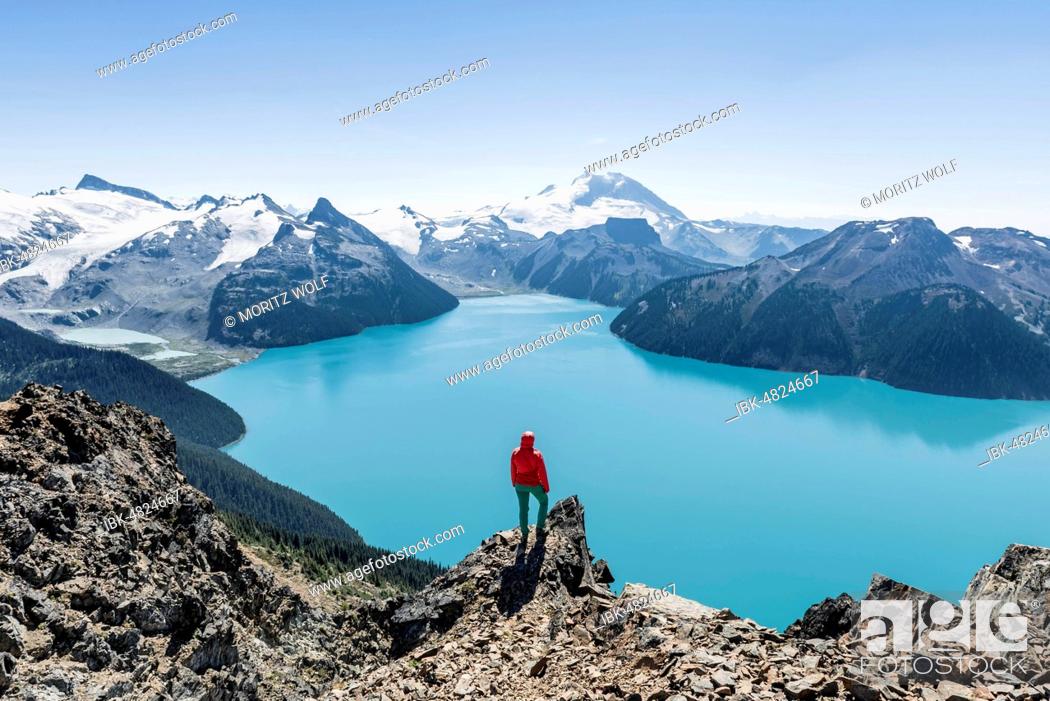 Stock Photo: View from Panorama Ridge Hiking Trail, Hiker on a Rock, Garibaldi Lake, Guard Mountain and Deception Peak, Back Glacier, Garibaldi Provincial Park.