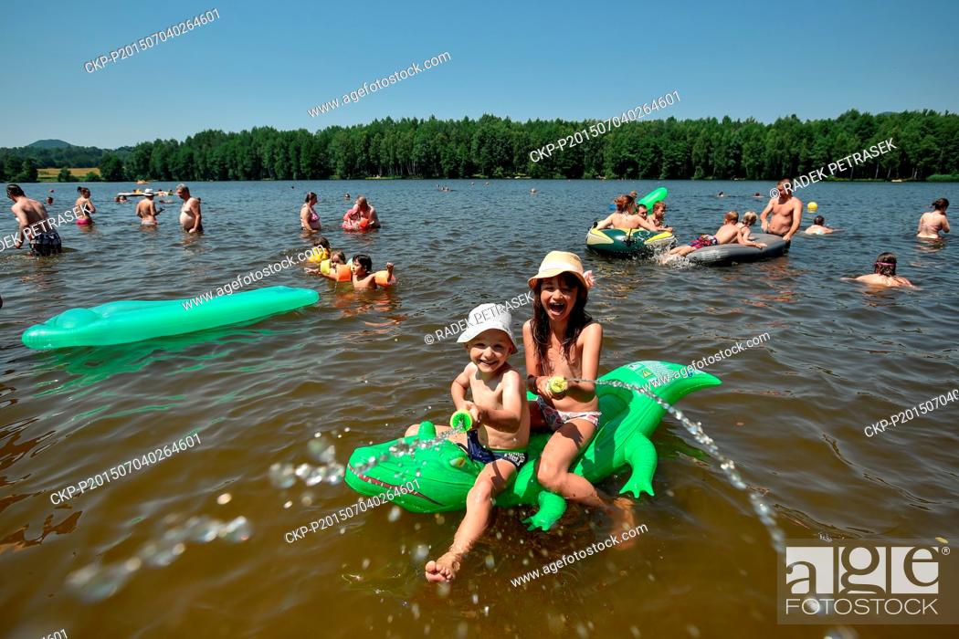 Stock Photo: People enjoy a hot sunny day at the outdoor swimming pool Sloup v Cechach, Northern Bohemia, Czech Republic, on Saturday, July 4, 2015.