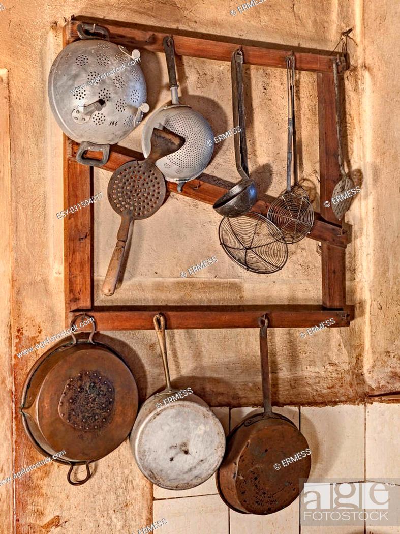 kitchenware hanging in the kitchen of an old country house   retro ...