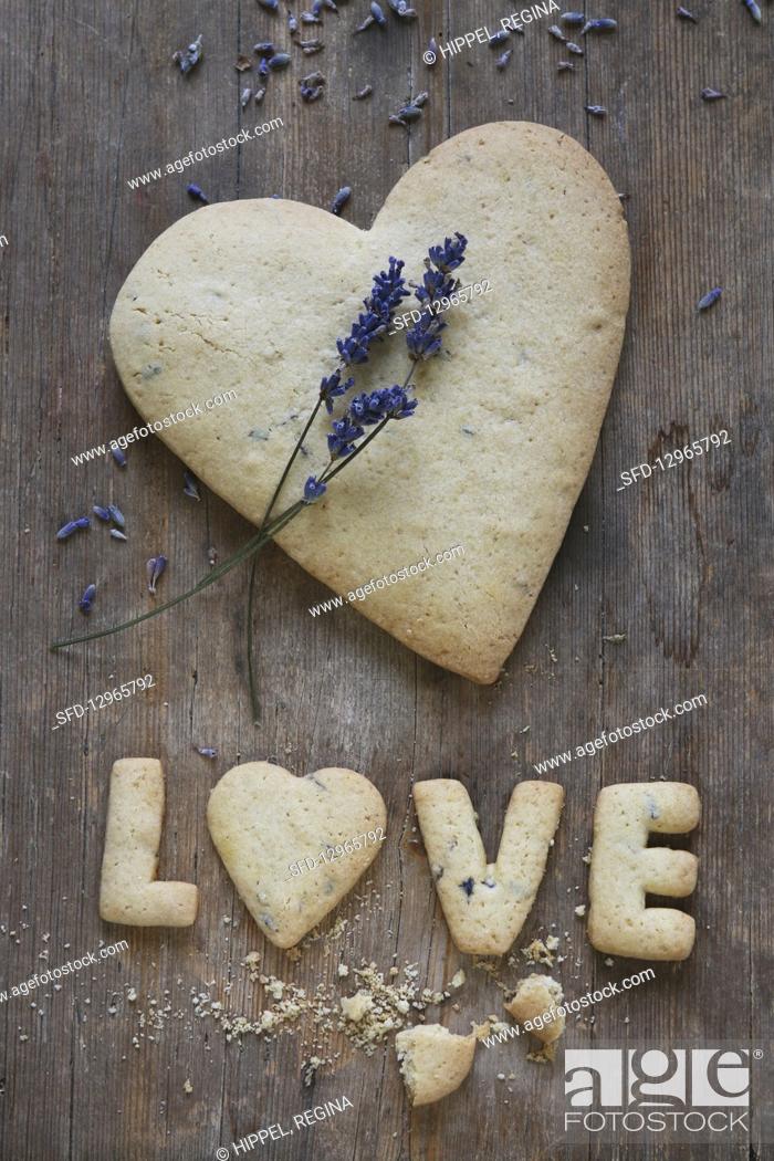 Stock Photo: A heart-shaped, gluten-free shortbread biscuit with lavender and the word 'Love'.