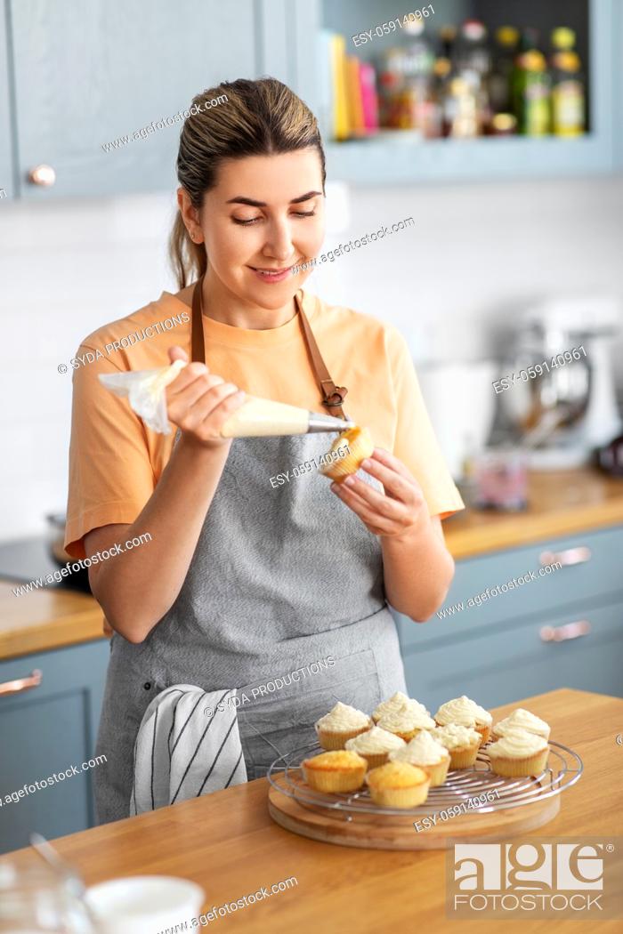 Stock Photo: woman cooking food and baking on kitchen at home.