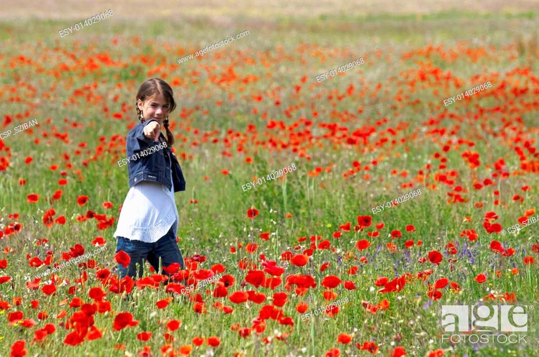 Stock Photo: Girl with poppies pointing.
