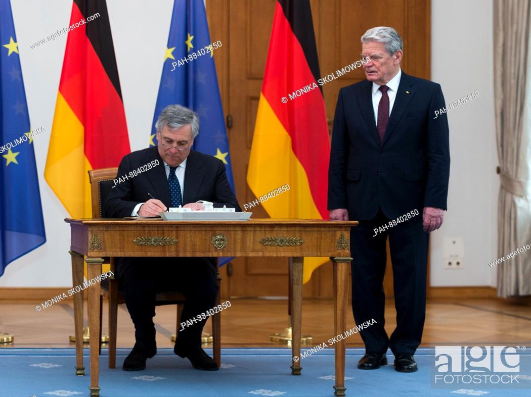 Stock Photo: The President of the European Parliament, Antonio Tajani, signs the golden book next to German President Joachim Gauck at Bellevue palace in Berlin, Germany.
