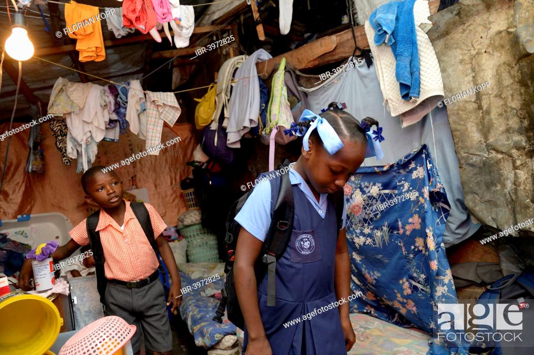 Stock Photo: Brother and sister in school uniforms, Camp Icare for earthquake refugees, Fort National, Port-au-Prince, Haiti.