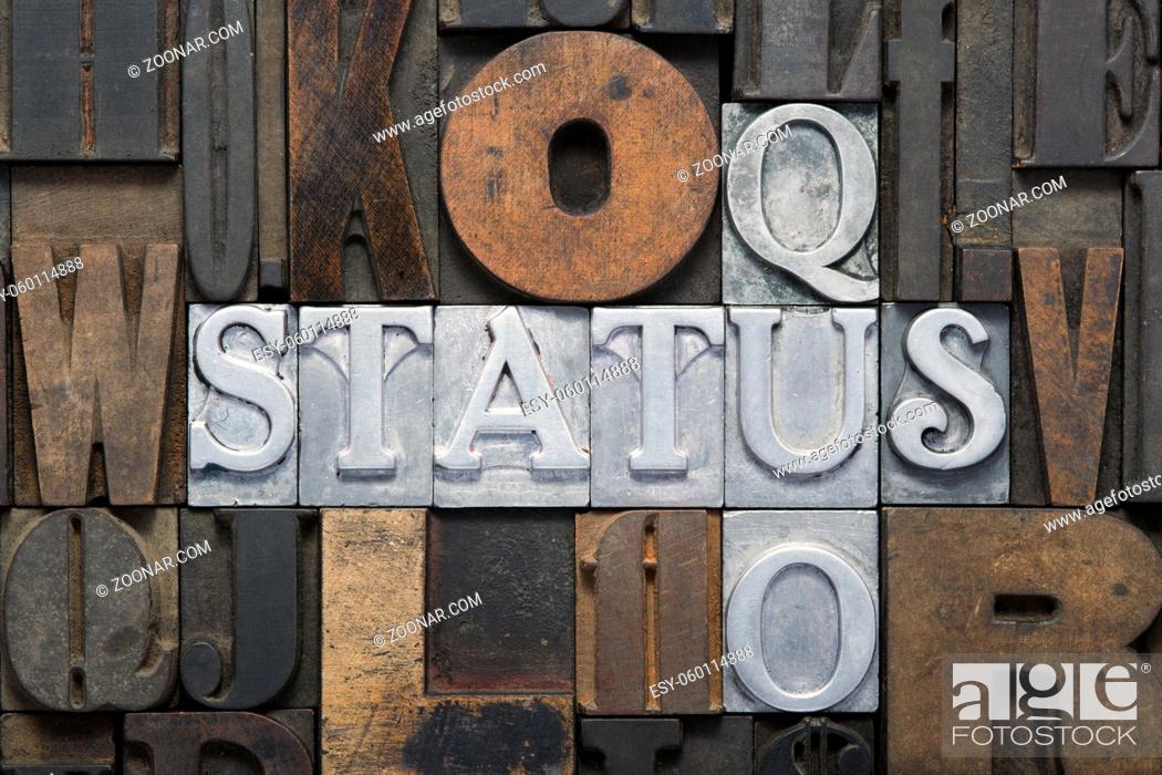 Stock Photo: status quo cross words made from metallic letterpress blocks in mixed wooden letters.