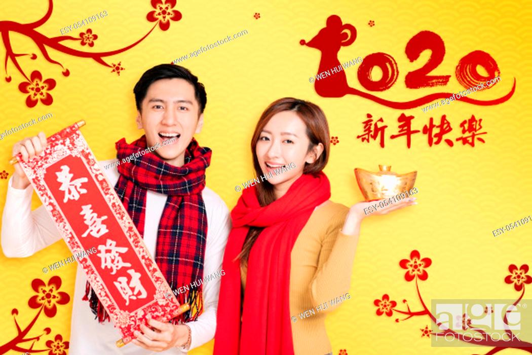 Imagen: asian young couple celebrating for chinese new year. chinese text happy new year 2020.