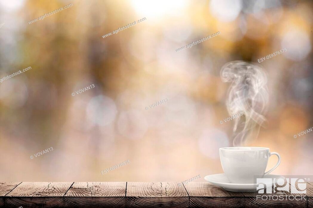 Stock Photo: hot coffee on the table on a blur background.