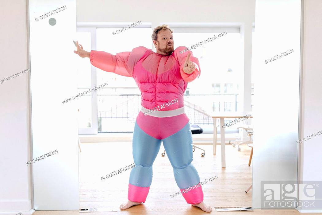 Imagen: Bouncer in office wearing pink bodybuilder costume.
