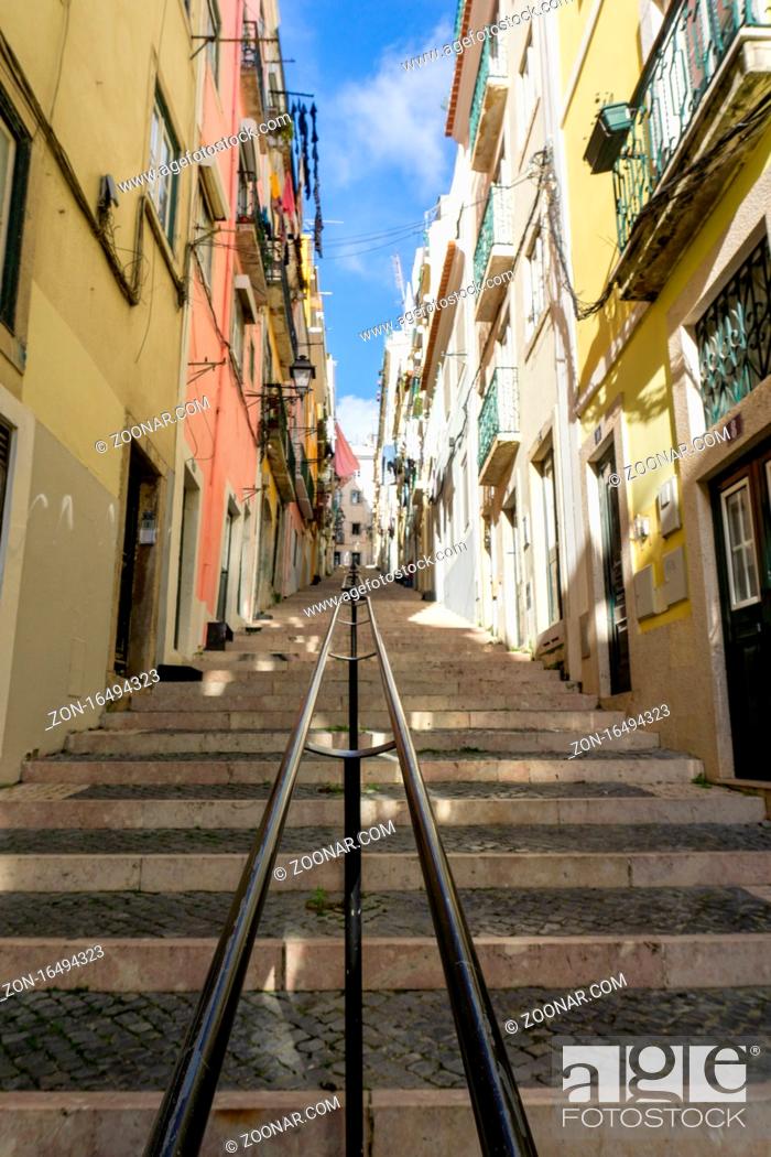Photo de stock: Lisbon, Portugal - 15 December 2020: stairs leading up a narrow alley in the historic city center of Lisbon.