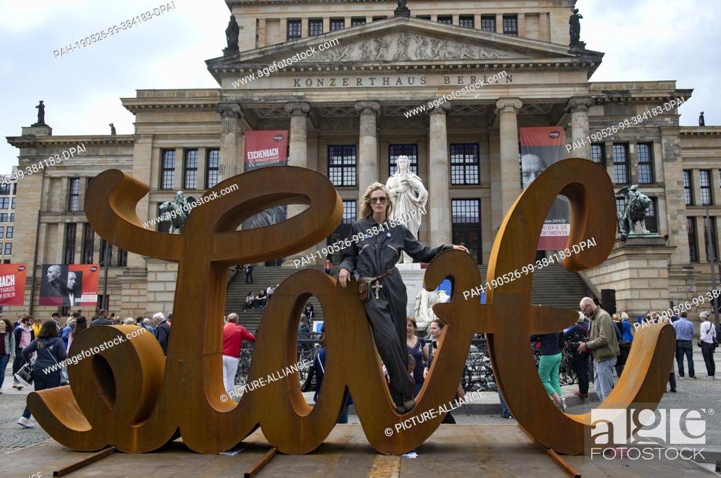Stock Photo: 26 May 2019, Berlin: The artist Mia Florentine Weiss stands on her sculpture ""LOVE HATE"" at the Gendarmenmarkt. There, supporters of the European initiative.
