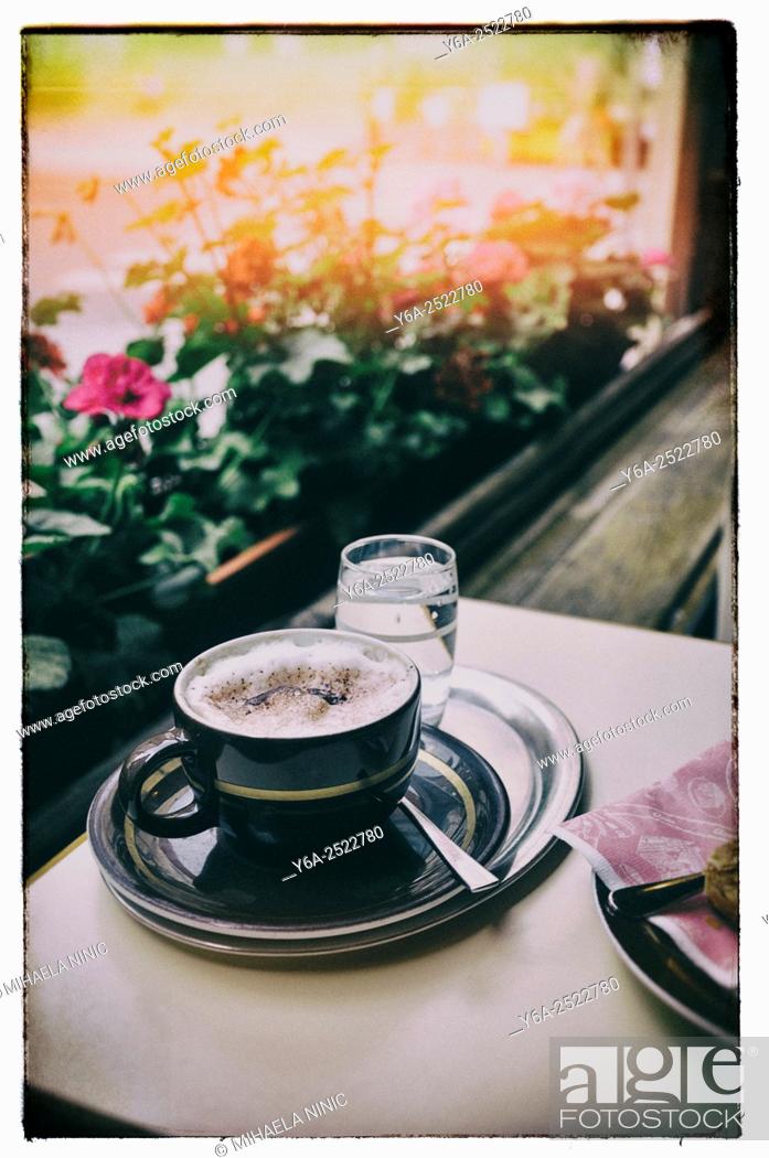 Stock Photo: Glass of water, teaspoon, coffee cup on a plate all on metal tray, close up, Austria, Vienna.