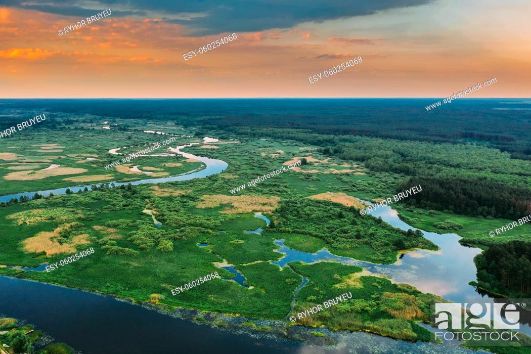 Stock Photo: Aerial View. Sunset Sky Above Green Forest, Meadow And River Landscape In Sunny Evening. Top View Of European Nature From High Attitude In Summer Sunrise.