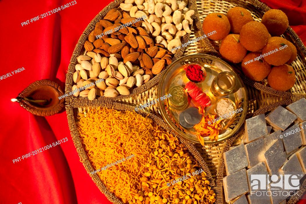 Assorted Diwali sweets and snacks with Diwali diya, Stock Photo, Picture  And Royalty Free Image. Pic. PNT-PIRF-20121004-SA0123 | agefotostock
