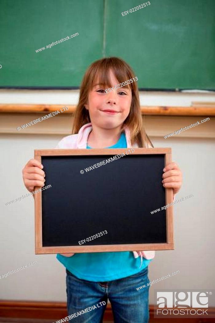 Stock Photo: Portrait of a smiling girl holding a school slate.
