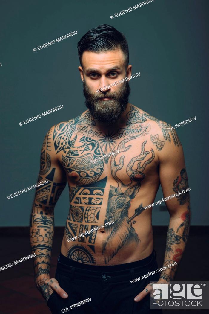 Portrait of young man with beard, bare chest covered in tattoos, Stock Photo, Picture And Royalty Free Image. Pic. CUL-IS09BD8OV
