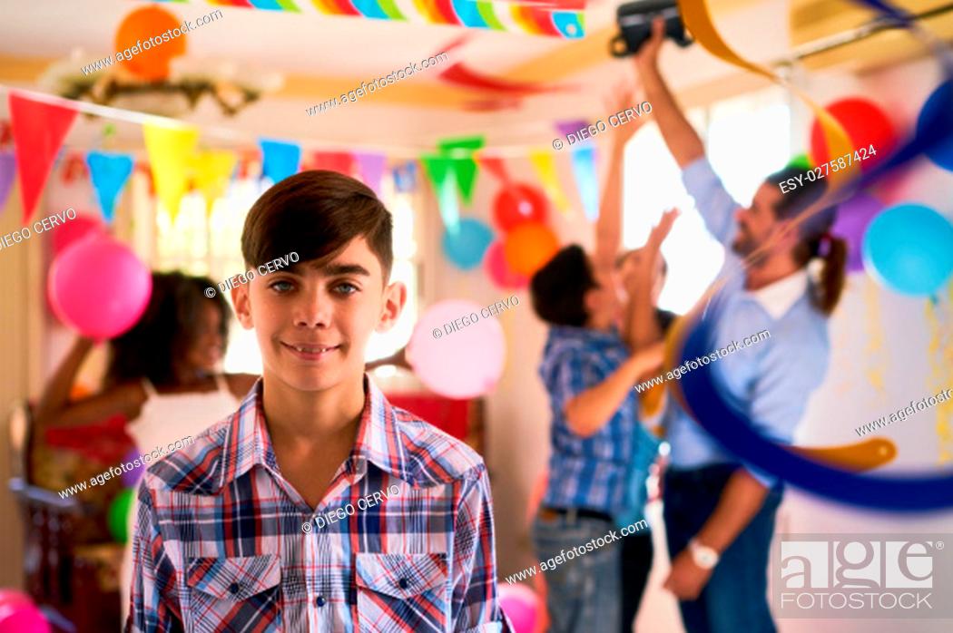 Stock Photo: Group of happy children celebrating birthday at home, kids and friends having fun at party. Portrait of happy latino boy smiling.