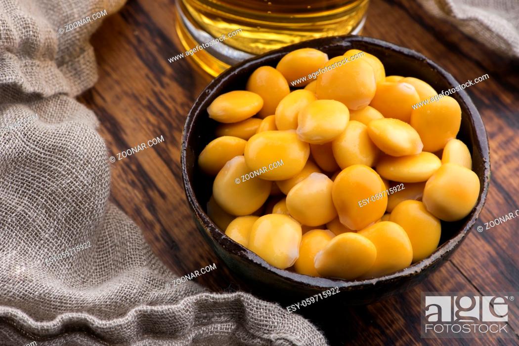 Stock Photo: Tasty lupins and glass of beer. Beverage, legume.