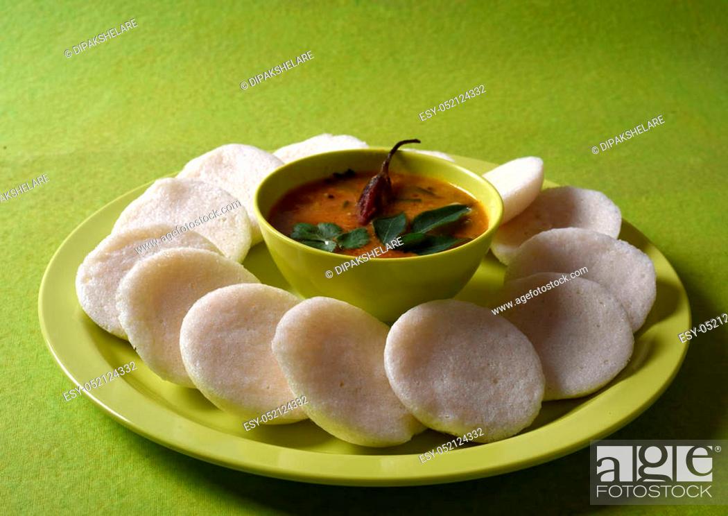 Stock Photo: Idli with Sambar in bowl on green background, Indian Dish: south Indian favourite food rava idli or semolina idly or rava idly.