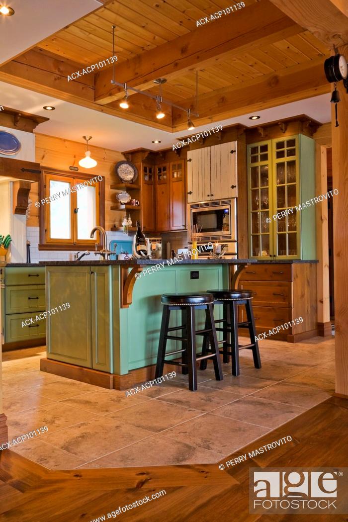 Green And Brown Wooden Island With Black Granite Countertop And
