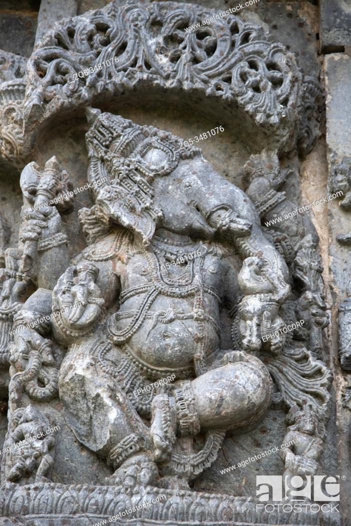 Stock Photo: Carved Ganesha standing idol on the outer wall of Kedareshwara Temple, Halebidu, Karnataka, India.