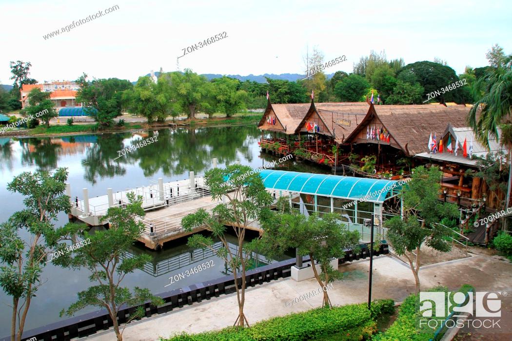 Stock Photo: Pier and floating restauran near bridge on the river Kwai, Thailand.