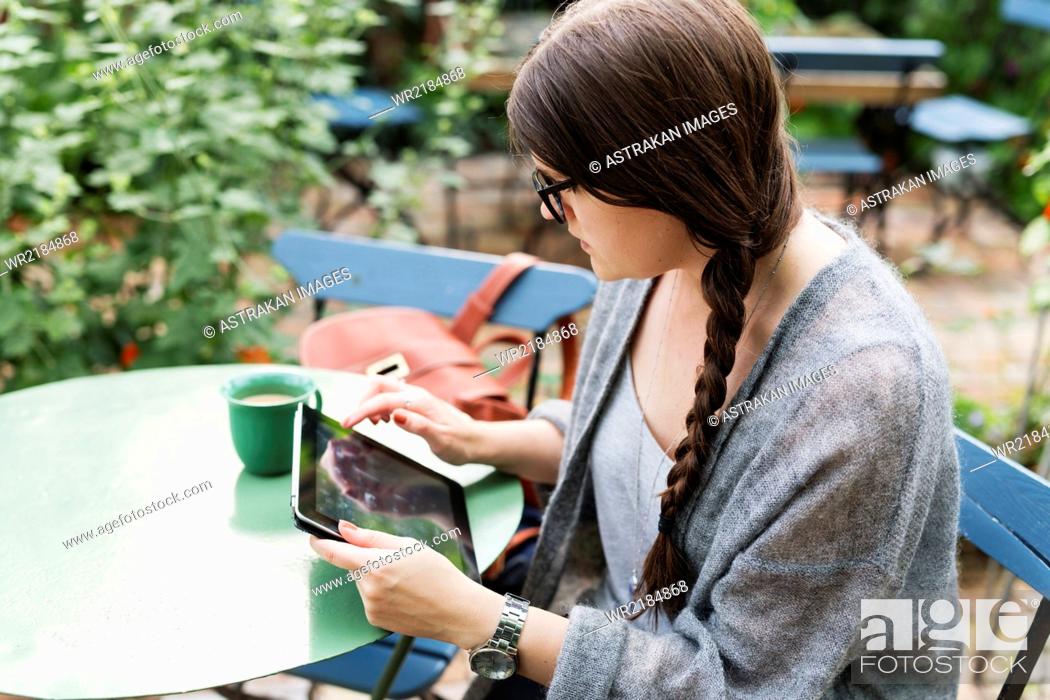 Stock Photo: High angle view of woman working on tablet in coffee break at greenhouse.