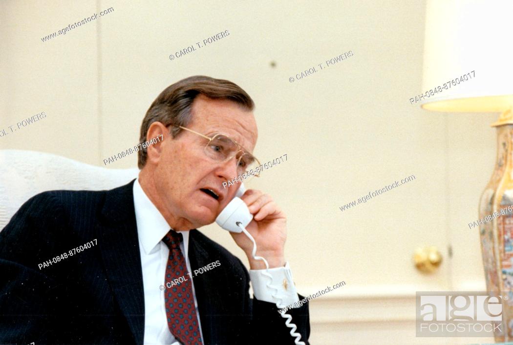 Stock Photo: United States President George H.W. Bush makes a telephone call from the Oval Office of the White House in Washington, DC to the Roe v.