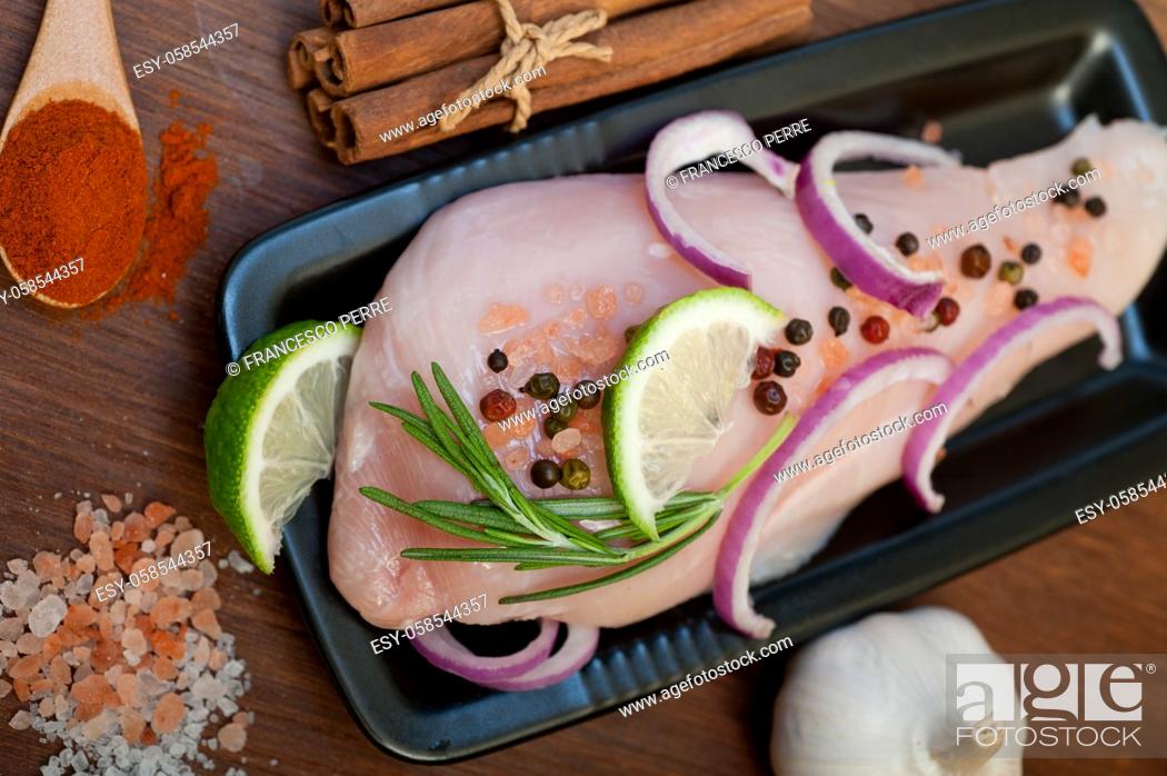 Stock Photo: fresh organic chicken breast with herbs and spices.