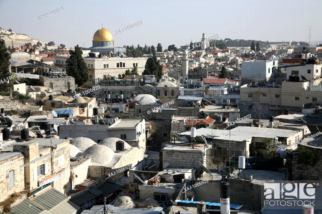 Stock Photo: Rooftops full of chimneys and communications equipment in the old city section of Jerusalem  Nearby dome of the rock.