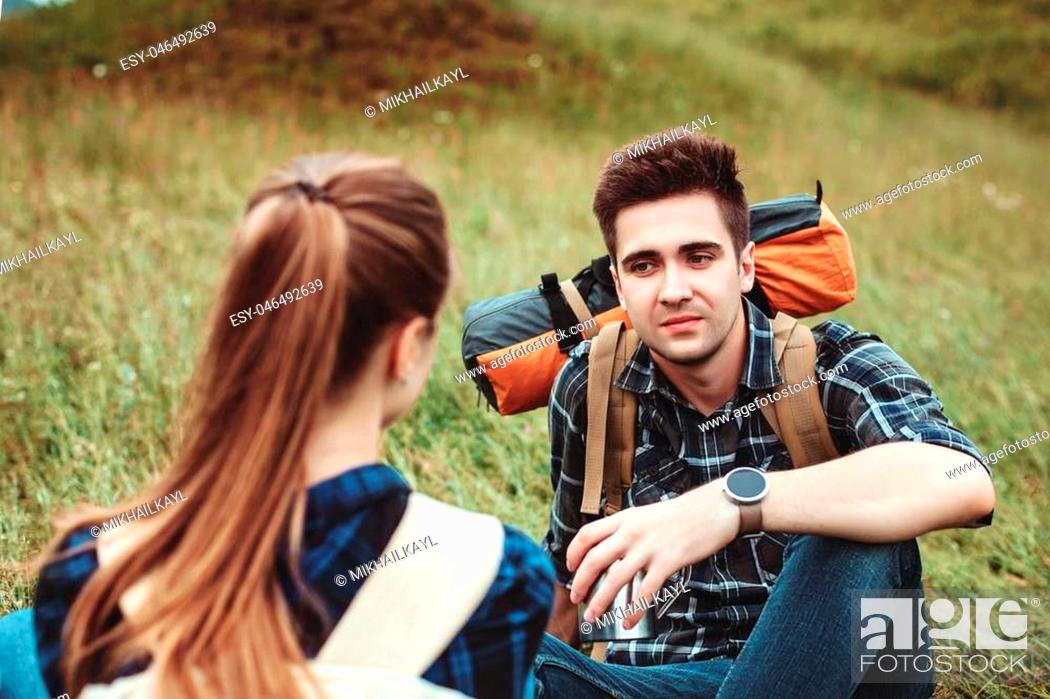 Stock Photo: A couple of tourists Hiking backpacks in camp on time travel. The concept of active rest.