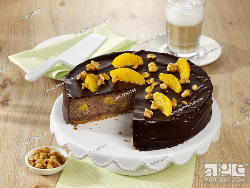 Stock Photo: Chocolate cheesecake with orange and peanuts.