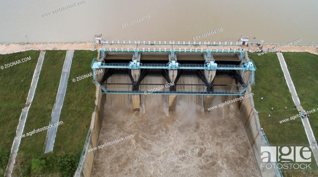 Stock Photo: Close up Aerial bird eye of water reservoir flood gates open to release water from dam at raichur, India.