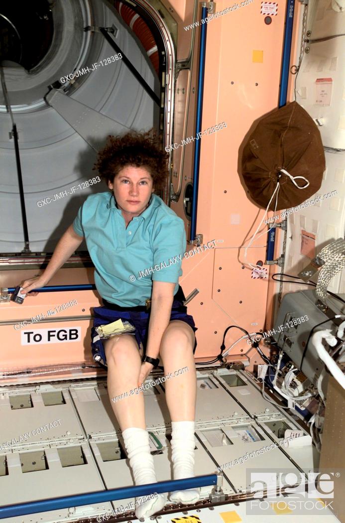 Stock Photo: Astronaut Susan J. Helms, Expedition Two flight engineer, pauses from moving through the Node 1 Unity module of the International Space Station (ISS) to pose.