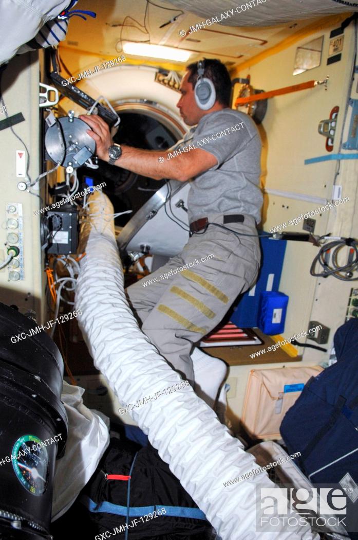 Stock Photo: Russian cosmonaut Anton Shkaplerov, Expedition 30 flight engineer, conducts an active session for the Russian experiment KPT-10 Kulonovskiy Kristall (Coulomb.