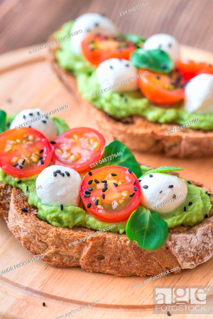 Stock Photo: Sandwiches with avocado paste, cherry tomatoes and mozzarella.