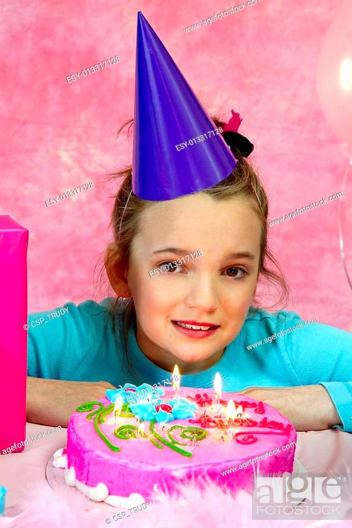 Stock Photo: Girl Blowing out Birthday Candles.