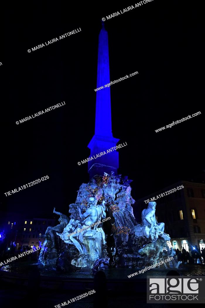 Stock Photo: The Fontana dei quattro fiumi (Fountain of the four rivers) in Piazza Navona illuminated with light shows each night for the duration of the Christmas season.