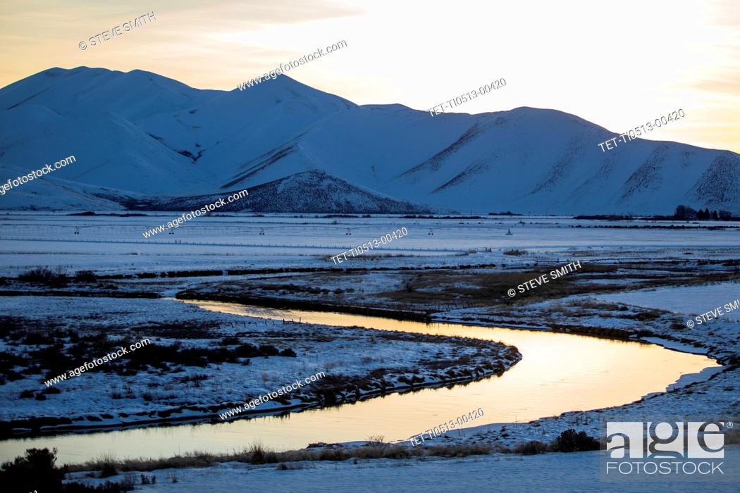 Stock Photo: River and mountains at sunrise in Picabo, Idaho.