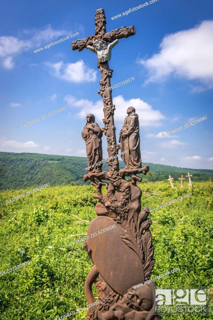 Stock Photo: Old rusty cross on a abandoned cemetery near ruined castle in former Chervonohorod village in Zalischyky region, Ternopil Province, Ukraine.