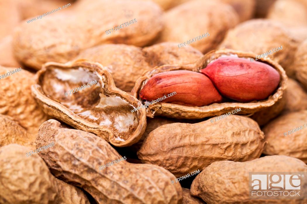 Stock Photo: Close view detail of a bunch of peanuts, one open in the middle.