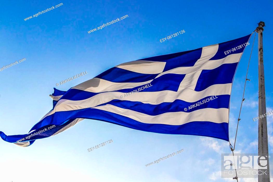 Stock Photo: Greek blue and white flag with blue sky background at the Acropolis of Athens in Greece's capital Athens in Greece.